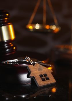 Auction or law concept. House key and judge gavel in notary office.